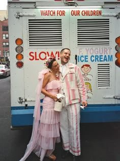 a man and woman standing in front of a ice cream truck