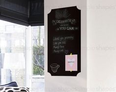 a bedroom with a chalkboard on the wall