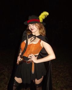 a woman dressed up as a witch in the dark