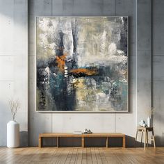 an abstract painting hangs on the wall above a coffee table