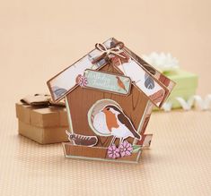 a birdhouse shaped gift box sitting on top of a table