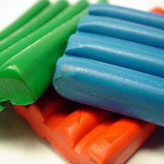 three different colored toothbrushes stacked on top of each other