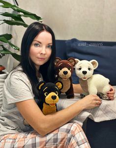 a woman sitting on a couch with four stuffed animals in front of her, one is holding a teddy bear