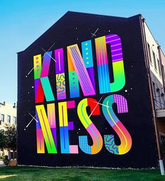 a large advertisement on the side of a building that says kind of niceness in multicolored letters