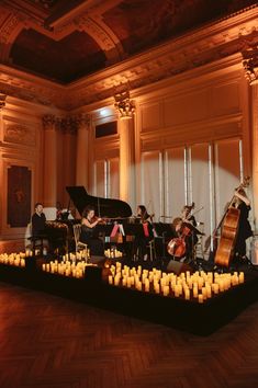 a group of people that are playing some kind of musical instrument in a large room