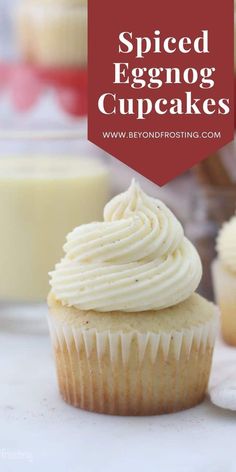 an eggnog cupcake with white frosting sitting on top of a counter