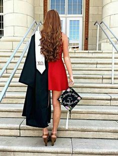 a woman in a graduation gown is walking down the stairs