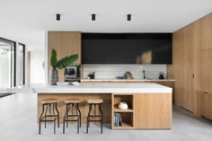 a kitchen with wooden cabinets and stools