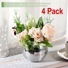 a vase filled with flowers sitting on top of a table next to a cup and saucer