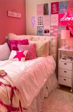 a bedroom with pink walls and lots of pillows on the bedspread in it