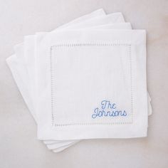 four embroidered napkins with the words the johnsons on them are stacked in rows