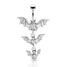 a pair of bats dangling from the end of a navel bar with an evil face on