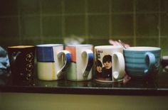 coffee mugs are lined up on the counter