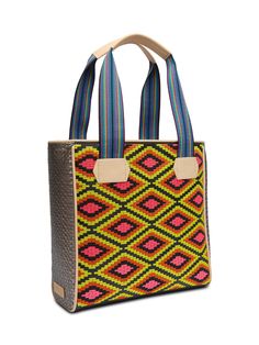 The Classic Tote has been our signature Consuela silhouette since the beginning. This bold and colorful embroidered tote bag holds its shape while carrying all of the essentials. You’re ready for anything that comes your way! Details & Sizing Rae embroidered pattern and Diamond exterior Lex woven side panels Interior slide pocket and zipper pocket Comfortable woven straps Trimmed in natural, untreated leather 13 ½” (W) x 13 ½” (H) x 5 ½” (D), 9 ¾" handle drop Made in Mexico Pattern placement may Casual Multicolor Embroidery Travel Bags, Casual Multicolor Embroidered Travel Bags, Casual Travel Bags With Multicolor Embroidery, Multicolor Bags With Braided Handles For Everyday, Everyday Multicolor Bags With Braided Handles, Casual Multicolor Embroidery Bags, Everyday Multicolor Handwoven Bag, Daily Use Bags With Multicolor Embroidery, Handwoven Multicolor Embroidered Bag For Everyday Use