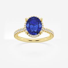 a yellow gold ring with a blue sapphire and diamonds