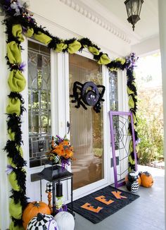 the front porch decorated for halloween with decorations