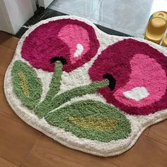 a bathroom rug with two flowers on it