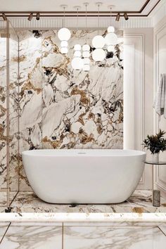 an elegant bathroom with marble walls and flooring, including a freestanding bathtub