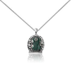 a necklace with a green and white stone in the shape of a door on a chain