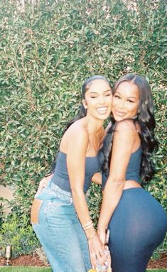 two women in tight jeans are posing for a photo with their arms around each other