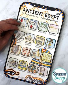 the ancient egypt sticker sheet is being held up by someone's hand on a marble surface