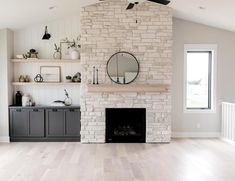 a living room filled with furniture and a fire place in front of a brick fireplace