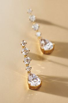 These stunningly luminous drop earrings by NADRI offer the perfect touch of glamour, featuring a line of radiant stones culminating in a larger pear-shaped gem. | Crystal Drop Earrings by NADRI in Gold, Women's, Gold/Plated Brass/Cubic Zirconia at Anthropologie Wedding Jewelry Gold Set, Wedding Accessories For Bride, Jewelry For Bride, Wedding Jewelry For Bride, Wedding Earring, Stone Accessories, Formal Jewelry, Jewelry Stones, Fancy Earrings