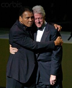 two men in tuxedos embracing each other