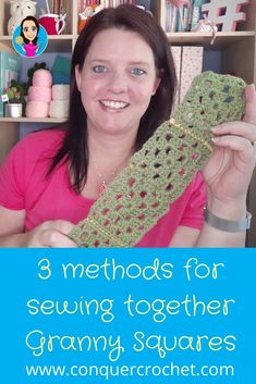 a woman holding up a crocheted granny's square