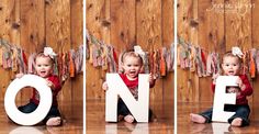 a baby is sitting on the floor and posing for a photo with one letter in front of her