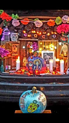 a car with decorations on the hood and candles in front of it that is decorated for halloween