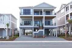 two story house with multiple balconies on the second floor