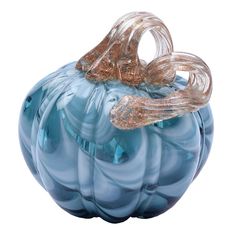 a blue glass pumpkin sitting on top of a white table