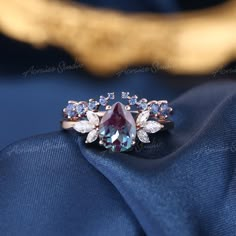 Unique Alexandrite Engagement Ring Set Women Rose Gold Pear shaped Vintage Alexandrite Ring Wedding Promise Rings Blue Sapphire band Link to the main ring: https://www.etsy.com/acraisejewelry/listing/974831833 Sapphire open band: https://www.etsy.com/acraisejewelry/listing/1057392293 Jewelry Information: ♡ Handmade, high-quality item ♡ Material: SOLID 14K/18K GOLD ( can be made in yellow/white/rose gold ) ♡ Engagement ring ♡ Center stone: Lab Alexandrite ♡ Size/Weight: 8x6mm ♡ Cut - Pear Shaped Pear Alexandrite Engagement Ring, Unique Sapphire Wedding Rings, Alexandrite Engagement Ring Set, Alexandrite Engagement Ring Vintage, Alexandrite Engagement Ring Silver, Promise Rings Blue, Untraditional Wedding Rings, Magical Engagement Rings, Non Diamond Wedding Rings