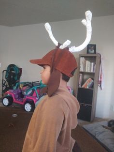 a young boy wearing a costume made to look like an antelope with horns