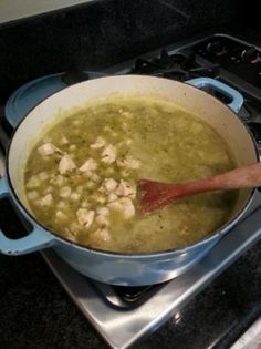 a pot filled with soup sitting on top of a stove