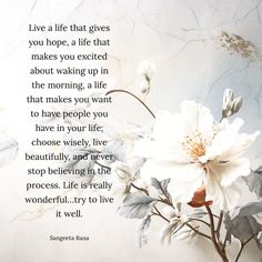 a white flower sitting on top of a table next to a quote that says live a life that gives you hope, a life that makes you excited about waking up