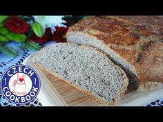 a loaf of bread sitting on top of a wooden cutting board