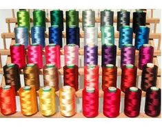 many spools of thread are arranged in rows