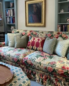 a living room filled with furniture and a painting on the wall