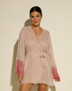 Sheer robe with lace sleeves. Beautifully detailed rigid semi-sheer lace. Mid-thigh length. Removable tie at waist. Lace trimmed long sleeves. Hand wash, do not dry in dryer. Sheer Long Sleeve Sleepwear For Spring, V-neck Lace Trim Robe For Daywear, Elegant Robe With Lace Long Sleeves, Elegant Long Sleeve Sleepwear With Lace Sleeves, Elegant Long Sleeve Sleepwear With Lace, Elegant Long Sleeve Robe With Lace Trim, Sheer Lace Long Sleeve Sleepwear, Long Sleeve Lace Sleepwear For Loungewear, Long Sleeve Lace Sleepwear For Lounge