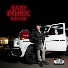 a man standing next to a white truck with the words baby don't sit on it