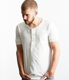 This versatile 207 short-sleeved Henley from Merz B. Schwanen is a heritage design with a comfortable fit. This brand is known for doing the simple things well, better than anyone else in fact, and this tee is a brilliant example of that. It is a standard fit that is not too slim and not too boxy. The sleeve is short but longer than a standard tee and is ribbed for the perfect comfort fit. The button plate is lined with three ivory coloured buttons which make a convenient opening to allow for ad Short Sleeve Henley, Buttoned Shirt, Mens Henley, Neckline Designs, Back Women, Denim Jean Jacket, Small Chest, Mother Of Pearl Buttons, Denim Pant