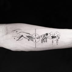 the creation of adam and eve tattoo on the left inner arm is shown in black ink