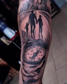 a man with a compass tattoo on his arm