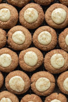 cookies with white icing and sprinkles on a cooling rack