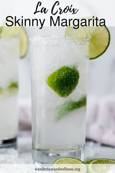 two glasses filled with lemonade and lime slices