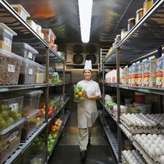 a woman in a chef's hat is walking down the aisle of a grocery store