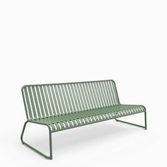 a green bench sitting on top of a white floor