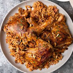 a white plate topped with chicken and rice